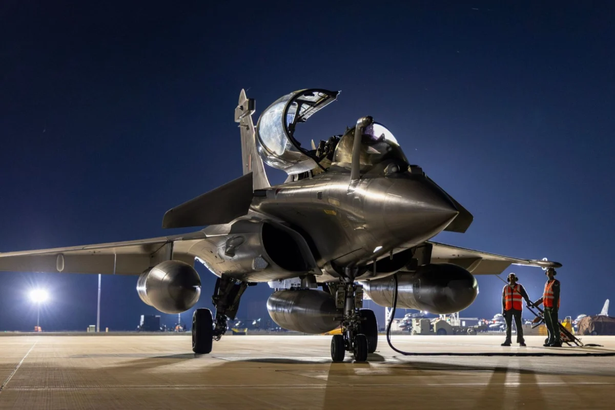 Indian Air Forces Rafale debuts at Exercise Pitch Black Fighter jet on a night time runway with cockpit open and two ground crew in orange vests nearby