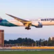 WestJet Boeing 787 Dreamliner landing with gear down over the runway during golden hour light tail visible
