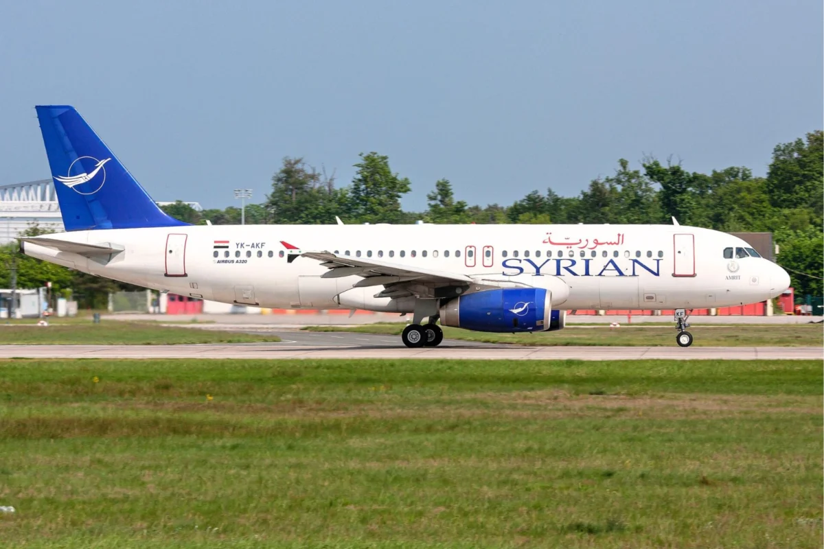 Airbus A320 of Syrian Airlines on taxiway white fuselage with blue SYRIAN lettering and blue tail logo
