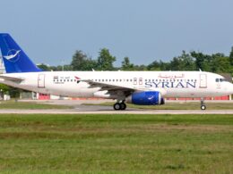 Airbus A320 of Syrian Airlines on taxiway white fuselage with blue SYRIAN lettering and blue tail logo