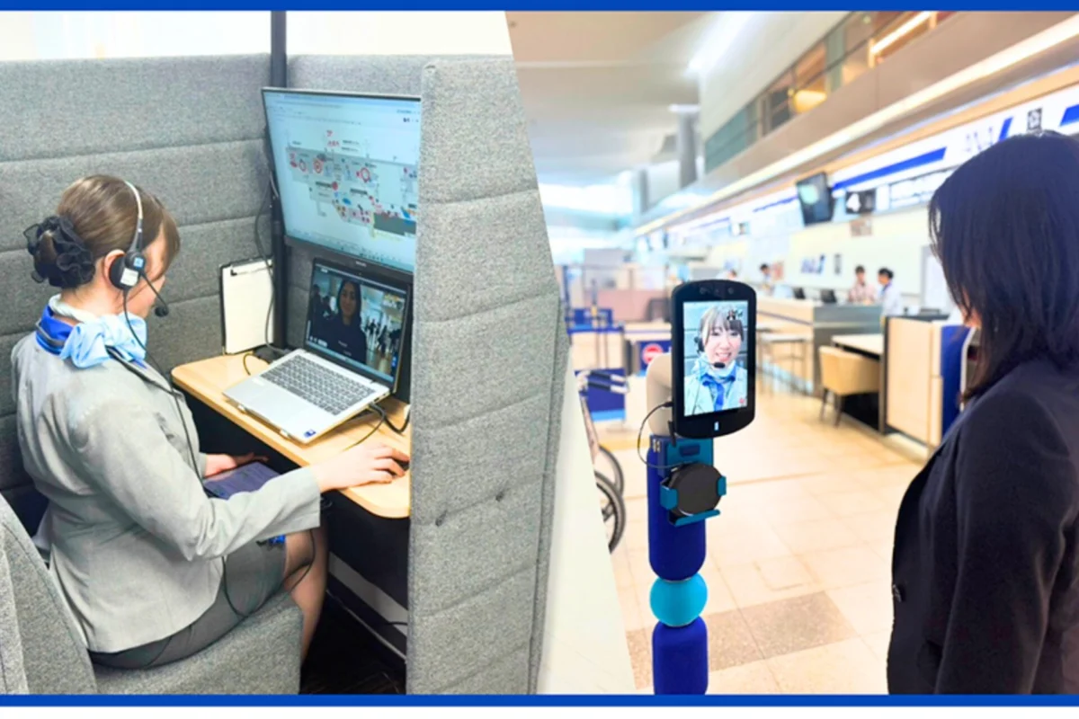 ANA launches robot support amid workforce shortage Agent with headset at a cubicle desk using dual computer screens for remote assistance