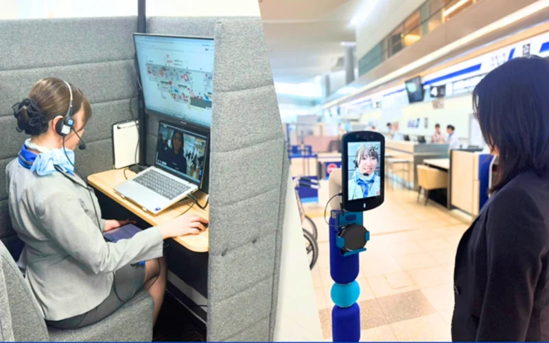 Agent with headset at a cubicle desk using dual computer screens for remote assistance