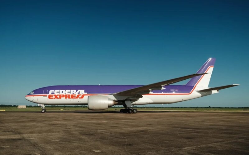 fedexs newly unveiled retro livery adorned by 777 n884fd v0 wzedlvmkotih1 FedEx Express cargo plane with purple and orange livery on a taxiway under a clear blue sky