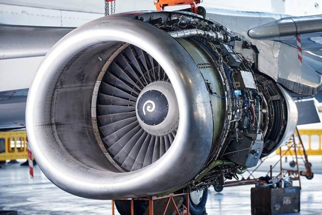 image Jet engine on an aircraft undergoing maintenance exposed turbofan with a spiral spinner inside the cowling