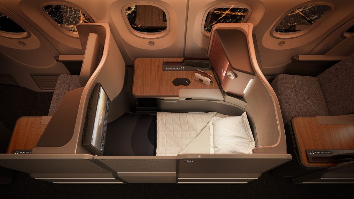 image Luxurious business class airplane cabin with a lie flat seat wood table and window view at night outside the windows