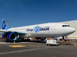 Israir passenger jet on the airport apron with blue logo on the fuselage and blue engine nacelles under a clear blue sky