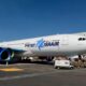 Israir passenger jet on the airport apron with blue logo on the fuselage and blue engine nacelles under a clear blue sky