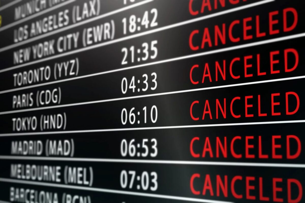 shutterstock 2730769001 1920x1152 Flight status board showing multiple flights with many as CANCELLED red across routes like Los Angeles New York City Toronto Paris Tokyo Madrid etc