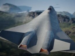 Top down rear view of a sleek fighter jet in flight over rugged terrain showcasing twin afterburner exhausts and sharp angular wings