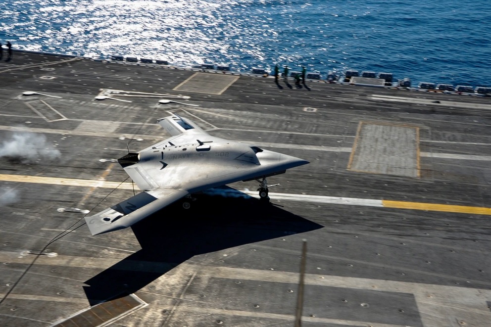 1000w q95 A gray F 35B stealth jet on the deck of an aircraft carrier with the ocean in the background