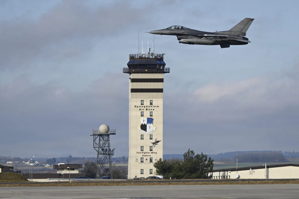A US Air Force F 16 Fighting Falcon flies past the control tower at Spangdahlem Air Base Germany A US Air Force F 16 Fighting Falcon flies past the control tower at Spangdahlem Air Base Germany