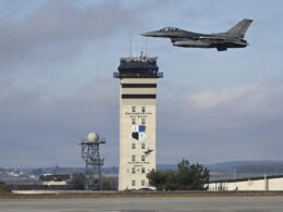 A US Air Force F 16 Fighting Falcon flies past the control tower at Spangdahlem Air Base Germany