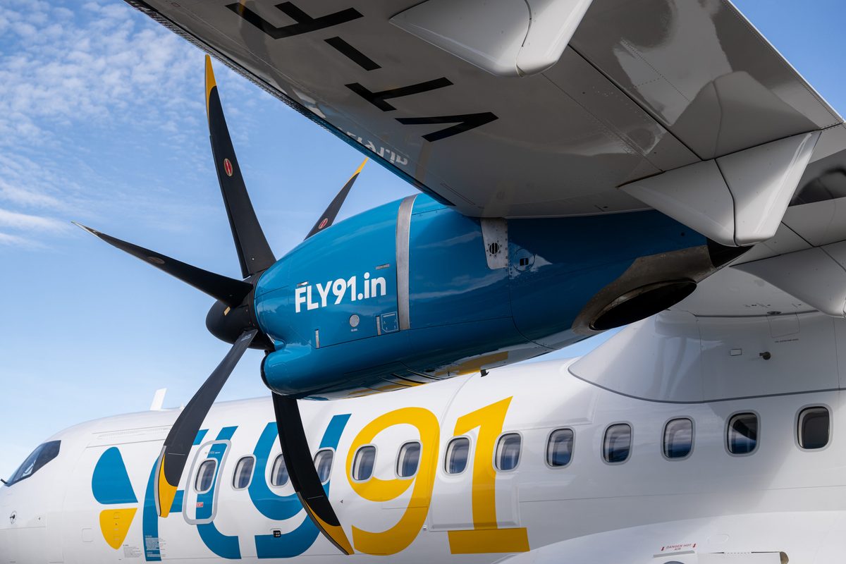 ATR 160370 HD scaled Close up of a blue turboprop aircrafts engine nacelle and two propeller blades with bold FLY91in branding on the fuselage under the wing