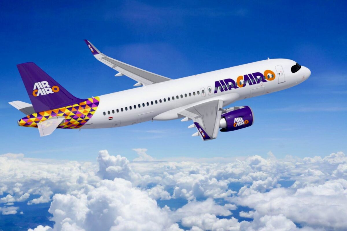 Air Cairo A320 1 Air Cairo passenger jet flying above the clouds with purple logo and yellow purple tail design visible