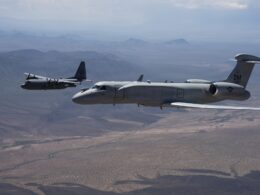 An EA 37B flies alongside an EC 130H Compass Call