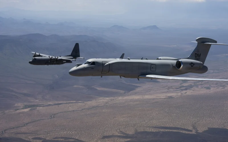 An EA 37B flies alongside an EC 130H Compass Call