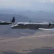 An EA 37B flies alongside an EC 130H Compass Call