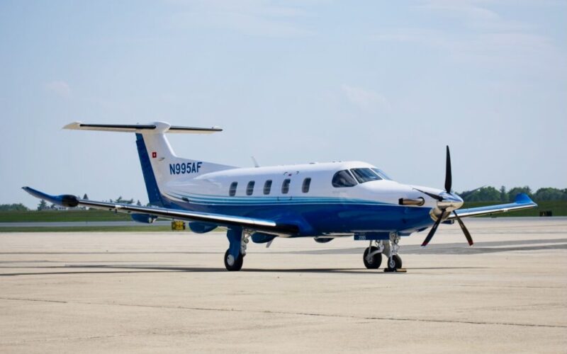 DSC 0307 Copy 2 1200x675 Blue and white twin engine propeller aircraft parked on a sunlit airport tarmac registration N995AF