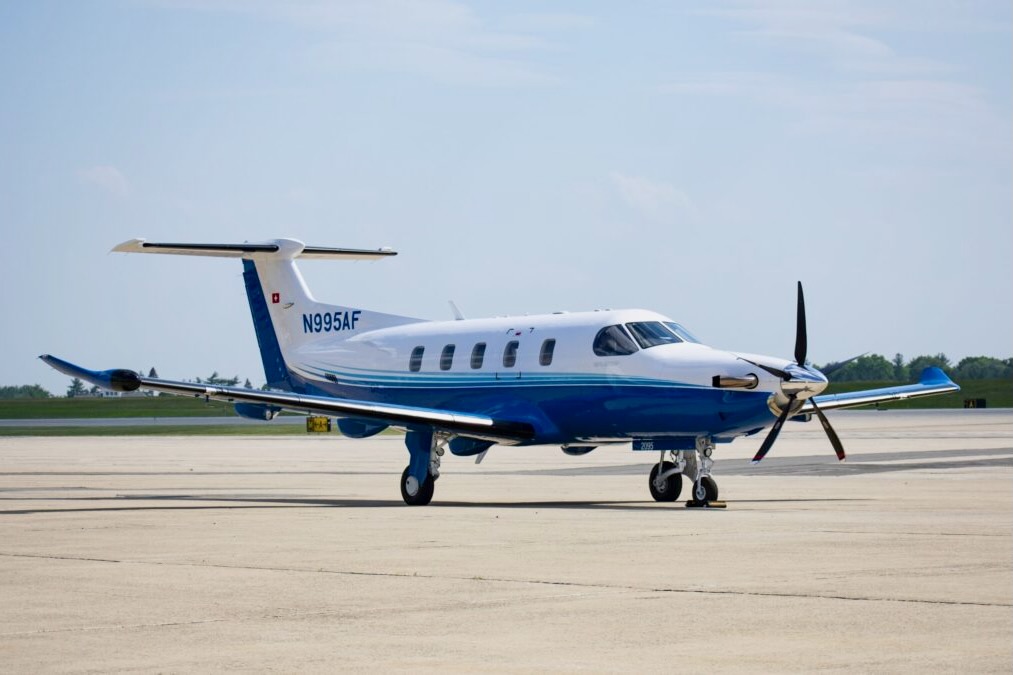DSC 0307 Copy 2 1200x675 Blue and white twin engine propeller aircraft parked on a sunlit airport tarmac registration N995AF