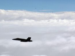 Finnish Air Force FA 18 Hornet flies alongside a formation of Russian military aircraft over the Gulf of Finland