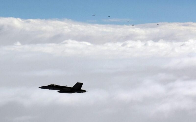 Finnish Air Force FA 18 Hornet flies alongside a formation of Russian military aircraft over the Gulf of Finland Finnish Air Force FA 18 Hornet flies alongside a formation of Russian military aircraft over the Gulf of Finland