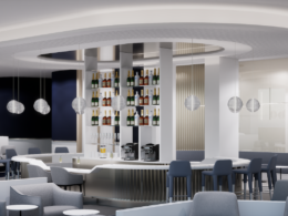 Modern circular bar with backlit shelves displaying bottles surrounded by grey seating in a sleek lounge