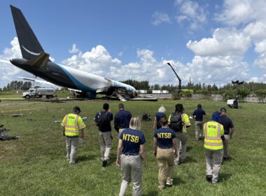 NTSB investigators examine the wreckage of 21 Air Flight 7598 after its runway overrun at Miami International Airport