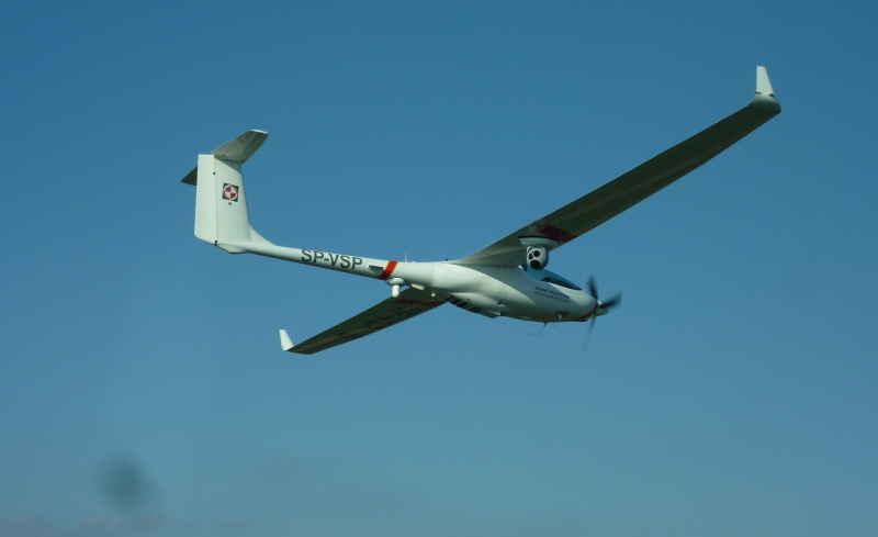 Polish Border Guard ASP S15 1 Stemme crewed surveillance aircraft White motor glider in flight with long wings against a clear blue sky registration SP VSP visible on the fuselage