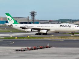 Mahan Air Airbus A340 taxiing on a runway at the airport with the green tailed logo visible on the fuselage
