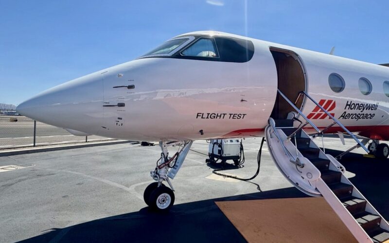 Recently Saved 1 of 1 2 Front three quarter view of a white test aircraft with the door open and stairs deployed on a tarmac labeled Flight Test and branded Honeywell Aerospace