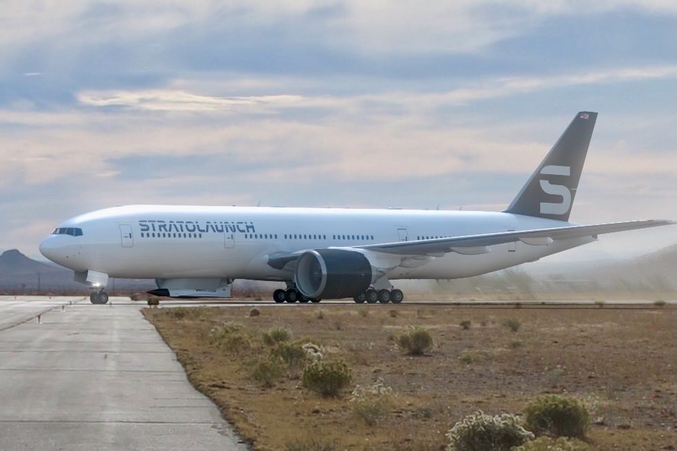 Recently Saved 1 of 1 25 Large white commercial airliner on a taxiway in a desert airfield with a dark tail fin bearing a light logo and distant mountains in the background