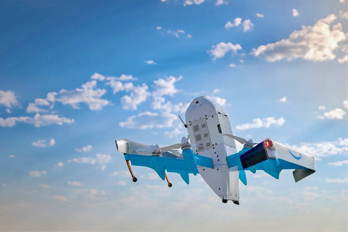 Recently Saved 1 of 1 26 Blue and white experimental aircraft in flight against a clear blue sky with scattered clouds landing gear visible