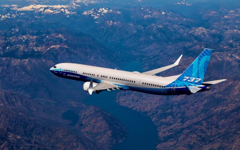 Recently Saved 1 of 1 9 Boeing 737 MAX in blue and white livery flying over a rugged mountain range beneath a clear sky