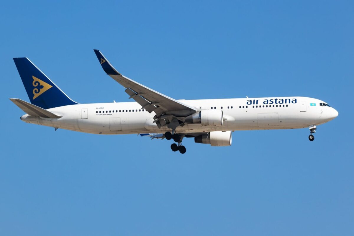 Air Astana to resume Dubai flights from October 2026 Air Astana passenger plane with landing gear down flying over a clear blue sky