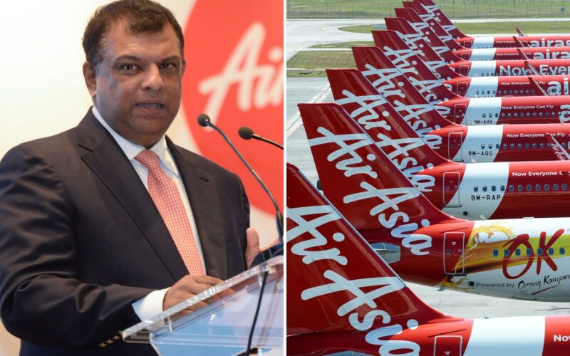 AirAsia denies bailout Fernandes calls claims ludicrous Man in a dark suit speaking at a podium with microphones