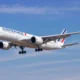Air France passenger jet taking off with landing gear down against a clear blue sky wings and engines visible karşı