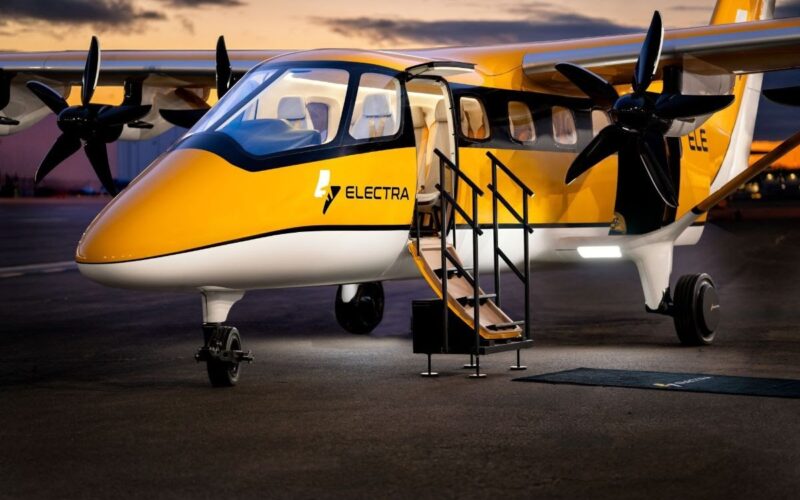 electra el9 Yellow and white Electra passenger aircraft parked on the tarmac with boarding stairs deployed and open door at dusk twilight