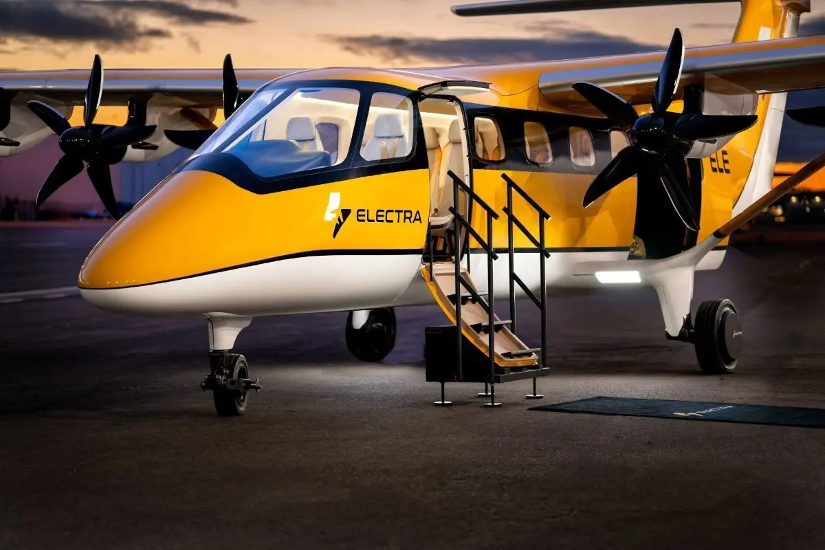 electra el9 Yellow and white Electra passenger aircraft parked on the tarmac with boarding stairs deployed and open door at dusk twilight