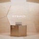 Bronze reception desk against a light tan wall with the Etihad logo and the word London nearby