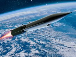 Rocket powered spacecraft soaring above Earth with a fiery exhaust plume