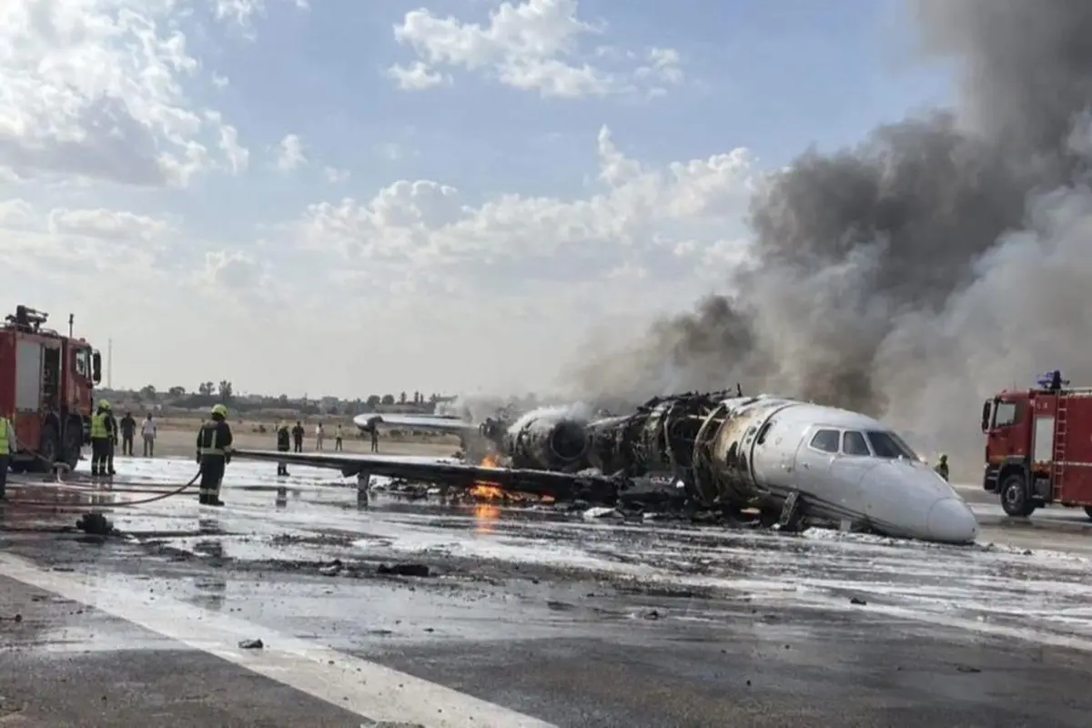 misrata citation 1200x800 Aircraft wreck on runway with fire and smoke firefighters respond with hoses and fire trucks nearby