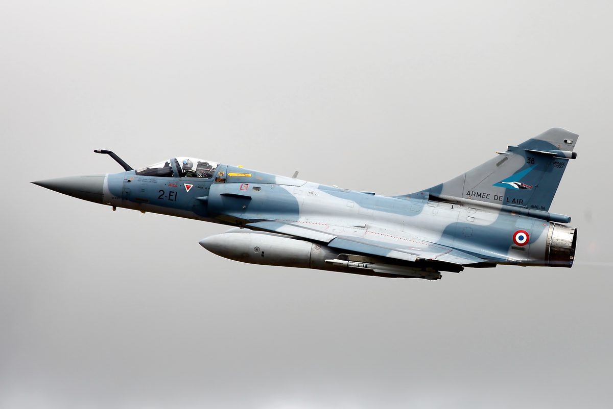 A French Air and Space Force Mirage 2000 5F French Air Force Dassault Mirage 2000 fighter jet in flight side view with markings ARME DE LAIR on the fuselage tail