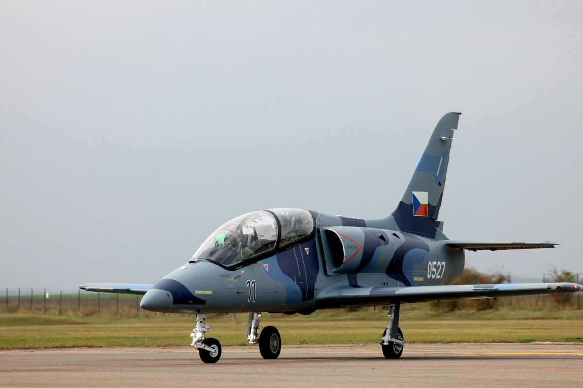 An Aero L 39 Skyfox trainer jet bearing Czech military markings photographed during Armenian Defense Minister Suren Papikyans visit to Aero Vodochody on October 20 2026 Side view of a gray blue Czech military fighter jet on a runway tail fin displaying the Czech flag emblem
