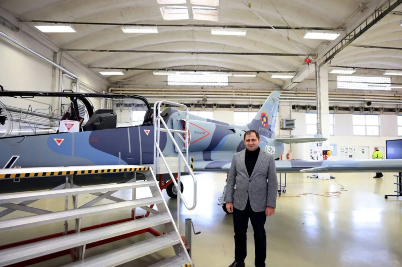 Armenian Defense Minister Suren Papikyan poses beside an Aero L 39 Skyfox jet bearing Armenian Air Force markings during a visit to Aero Vodochodys factory