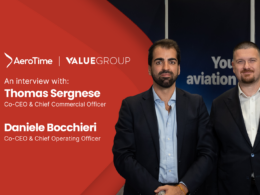 Two suited men posing on a split red and dark backdrop with AeroTime and ValueGroup logos interview banner shows names Thomas Sergnese and Daniele Bocchieri