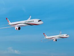 Three Biman Bangladesh Airlines planes in formation mid flight against a bright blue sky