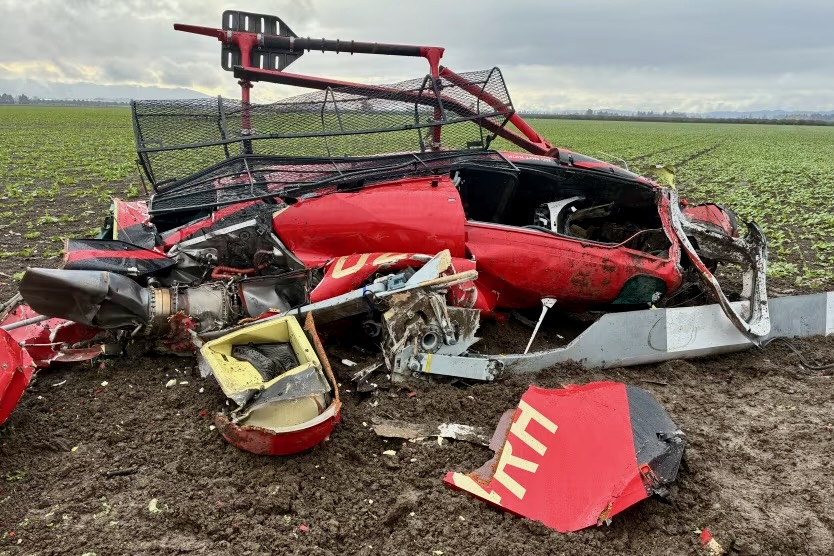 Recently Saved 1 of 1 16 Red aircraft wreckage on a dirt roadside in a field with twisted metal panels and scattered debris visible in the foreground