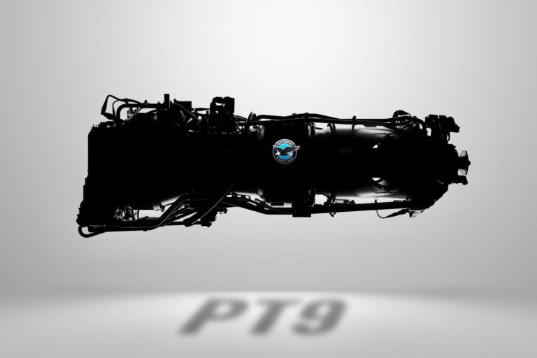 Silhouette of a large aircraft jet engine with a blue circular emblem on its side against a light gray background
