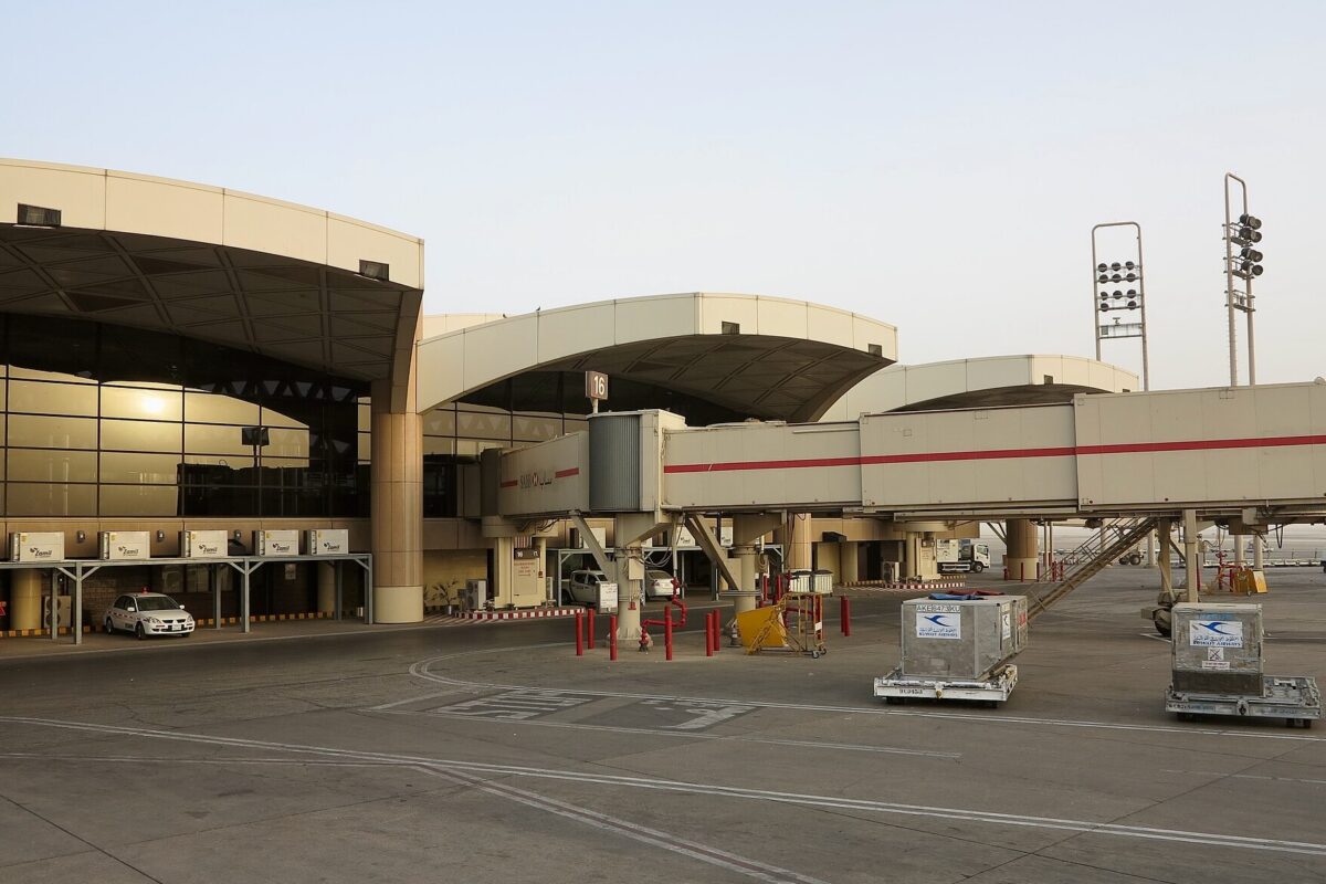 Recently Saved 1 of 1 2 Airport terminal with curved jet bridges and glass facade ground equipment and vehicles on the tarmac