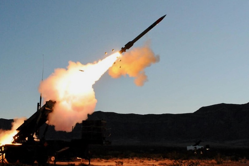 Recently Saved 1 of 1 36 Ground based missile launcher fires a rocket bright flame and smoke plume streaking into the sky with desert terrain in the background